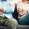 Couple with crossed arms sat next to each other | Goodwins Family Law Solicitors